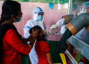A health official collects nasal and throat swab samples from a girl to test for the Covid-19 coronavirus at a primary health centre  in Siliguri on September 2, 2020. - India on August 30 set a coronavirus record when it reported 78,761 new infections in 24 hours the world's highest single day rise even as it continued to open up the economy. (Photo by DIPTENDU DUTTA / AFP) (Photo by DIPTENDU DUTTA/AFP via Getty Images)
