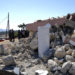 Firefighters stand next to a demolished Greek Orthodox church of Profitis Ilias after a strong earthquake in Arkalochori village on the southern island of Crete, Greece, Monday, Sept. 27, 2021. A strong earthquake with a preliminary magnitude of 5.8 has struck the southern Greek island of Crete, and Greek authorities say one person has been killed and several more have been injured. (AP Photo/Harry Nikos)