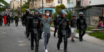 A man is arrested during a demonstration against the government of President Miguel Diaz-Canel in Arroyo Naranjo Municipality, Havana on July 12, 2021. - Cuba on Monday blamed a "policy of economic suffocation" of United States for unprecedented anti-government protests, as President Joe Biden backed calls to end "decades of repression" on the communist island. Thousands of Cubans participated in Sunday's demonstrations, chanting "Down with the dictatorship," as President Miguel Díaz-Canel urged supporters to confront the protesters. (Photo by YAMIL LAGE / AFP)